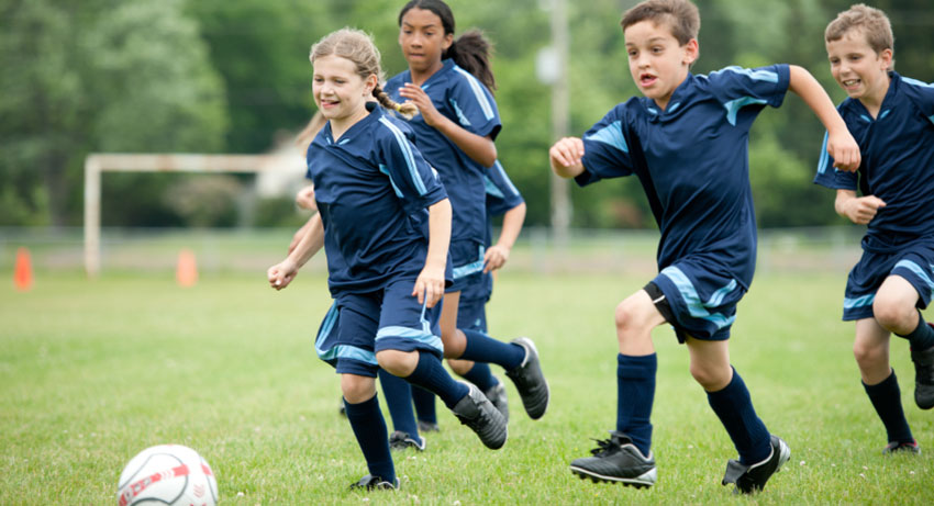 team members playing soccer